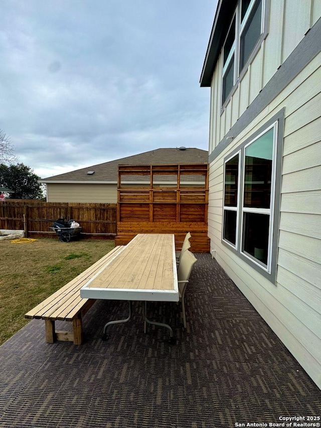 deck featuring a lawn and a patio area