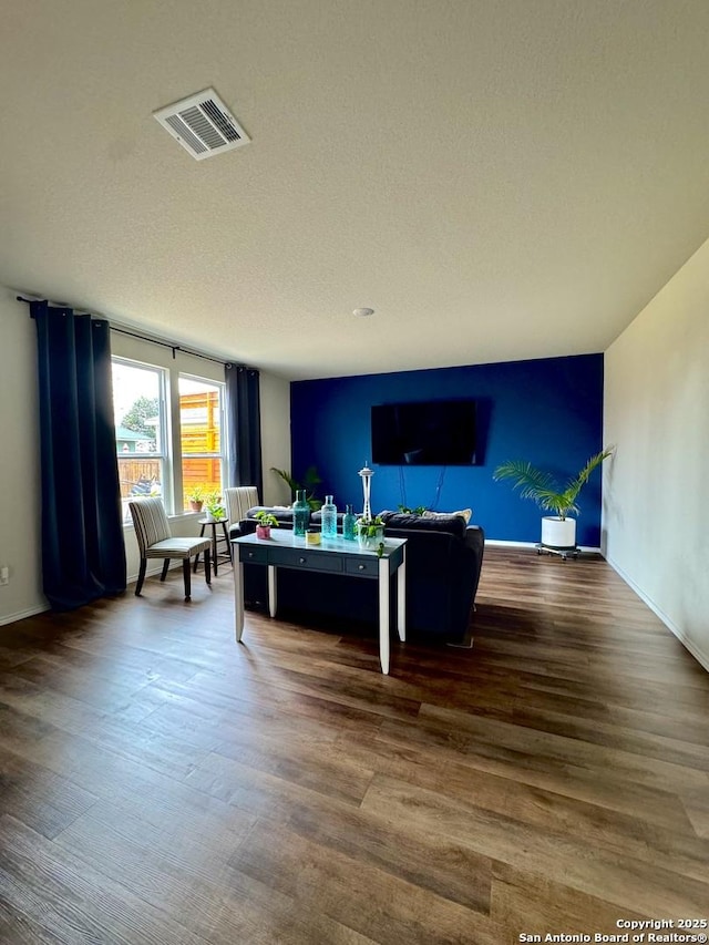 living room with hardwood / wood-style floors and a textured ceiling