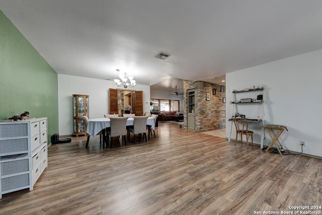 dining room featuring hardwood / wood-style floors and ceiling fan with notable chandelier