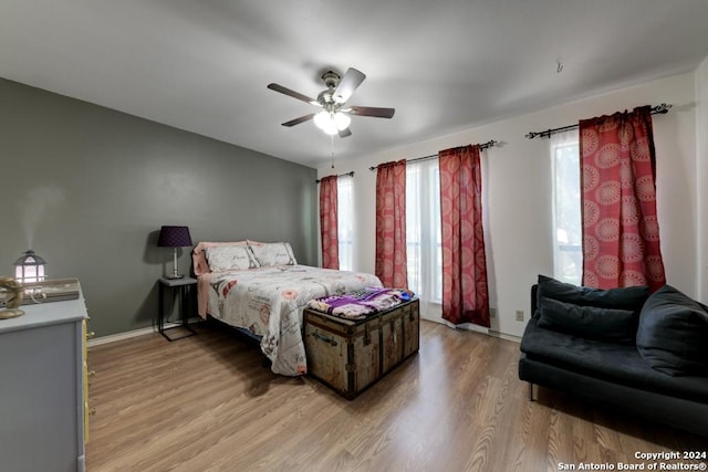 bedroom with ceiling fan and light wood-type flooring