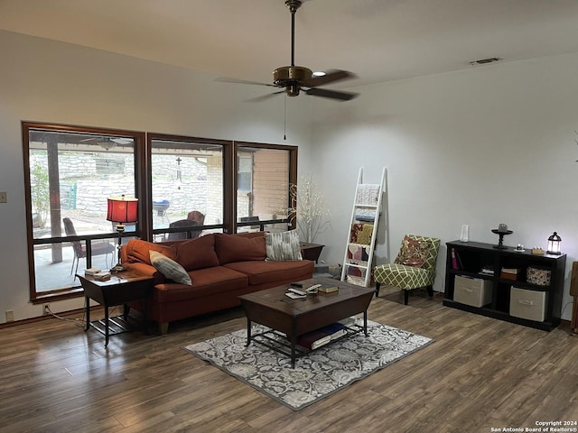 living room with dark wood-type flooring and ceiling fan