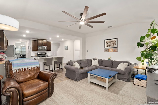 living room featuring ceiling fan and light hardwood / wood-style floors