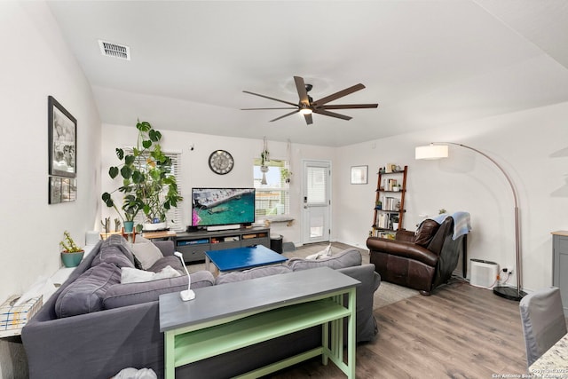 living room with ceiling fan and light hardwood / wood-style floors