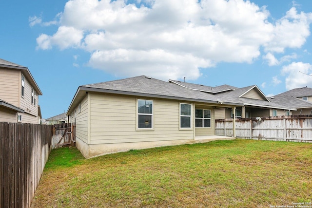 rear view of property with a lawn