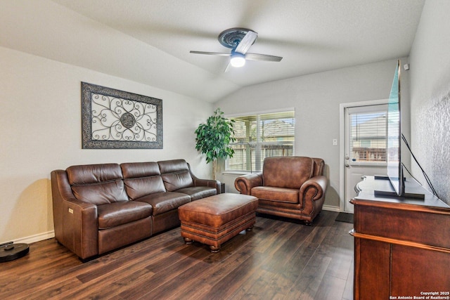 living room with dark wood-type flooring, ceiling fan, and vaulted ceiling