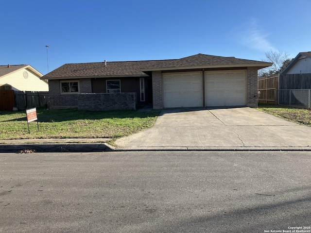 single story home featuring a garage and a front lawn