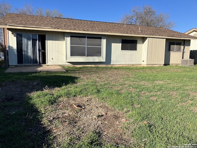 rear view of house featuring a lawn