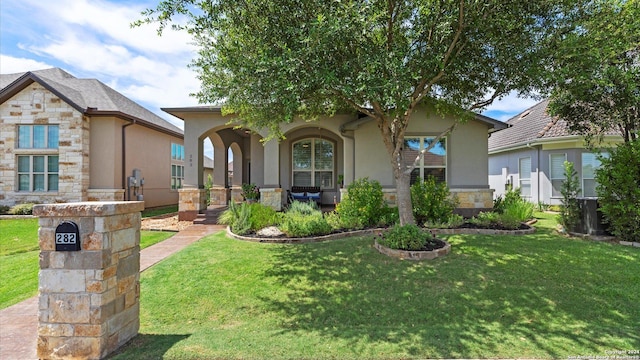 view of front facade with covered porch and a front lawn