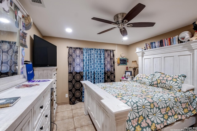 tiled bedroom featuring ceiling fan