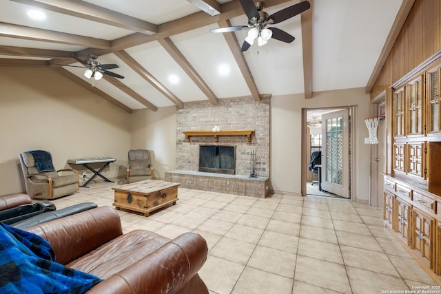 tiled living room featuring ceiling fan, a fireplace, and lofted ceiling with beams