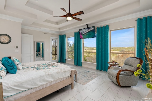 bedroom featuring ceiling fan, multiple windows, a tray ceiling, and ornamental molding