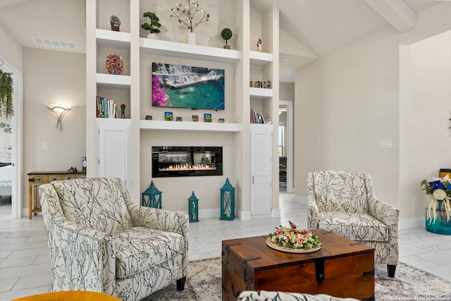 living room with built in features, marble finish floor, lofted ceiling, visible vents, and a glass covered fireplace