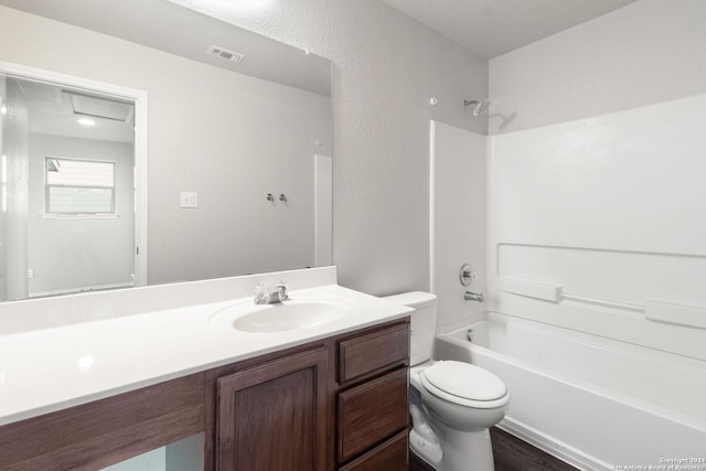 full bathroom with bathtub / shower combination, vanity, and toilet