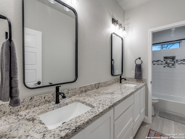 full bathroom with vanity, tub / shower combination, and toilet