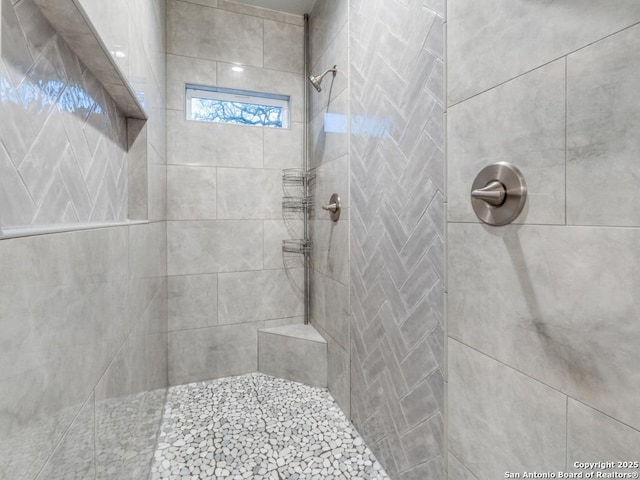 bathroom with tiled shower