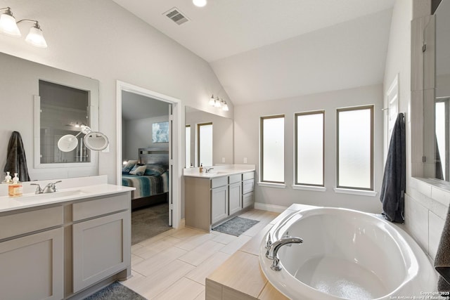 1905 High Bank, Seguin, TX 78155 - full bath with vaulted ceiling, healthy amount of natural light, a bath, two vanities, and ensuite bathroom