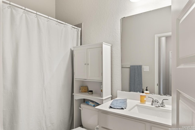1905 High Bank, Seguin, TX 78155 - full bath with toilet, vanity, a textured wall, and curtained shower
