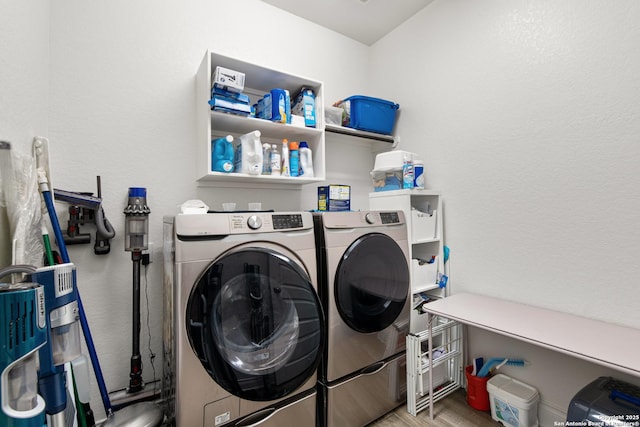 1905 High Bank, Seguin, TX 78155 - laundry room featuring washing machine and dryer, wood finished floors, and a textured wall