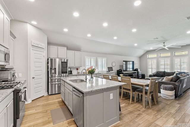1905 High Bank, Seguin, TX 78155 - kitchen with appliances with stainless steel finishes, a sink, recessed lighting, lofted ceiling, and light wood-style floors