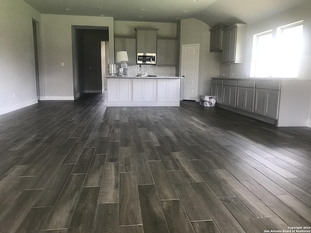 unfurnished living room featuring lofted ceiling