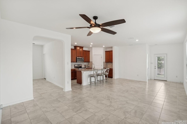 unfurnished living room featuring ceiling fan