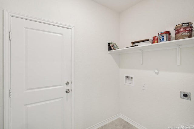 clothes washing area with washer hookup, hookup for an electric dryer, and light tile patterned floors