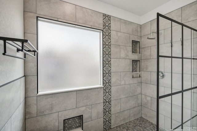 bathroom with a wealth of natural light and a tile shower