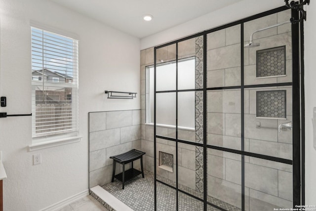 bathroom featuring plenty of natural light and a tile shower