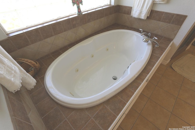 bathroom featuring a whirlpool tub and tile patterned floors