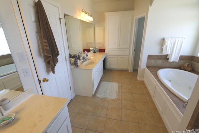 full bath featuring tile patterned flooring, vanity, and a tub with jets