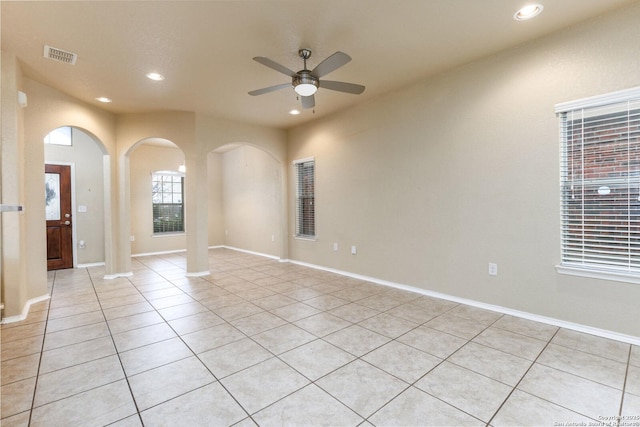 spare room with ceiling fan and light tile patterned floors