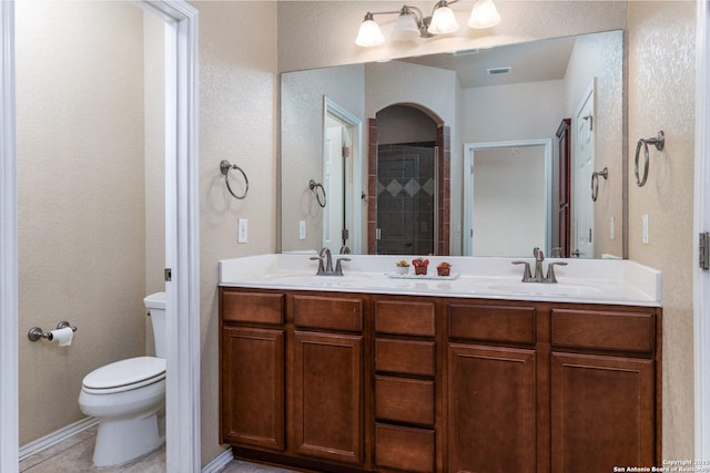 bathroom featuring vanity, tile patterned flooring, and toilet