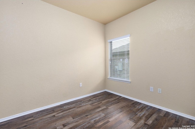 spare room featuring dark hardwood / wood-style floors