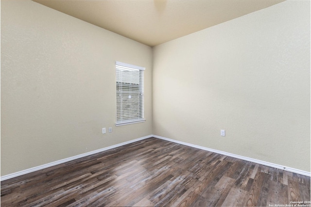 empty room with dark hardwood / wood-style flooring