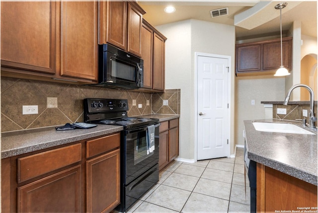 kitchen with sink, pendant lighting, decorative backsplash, and black appliances