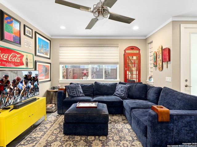 living room with ornamental molding and ceiling fan