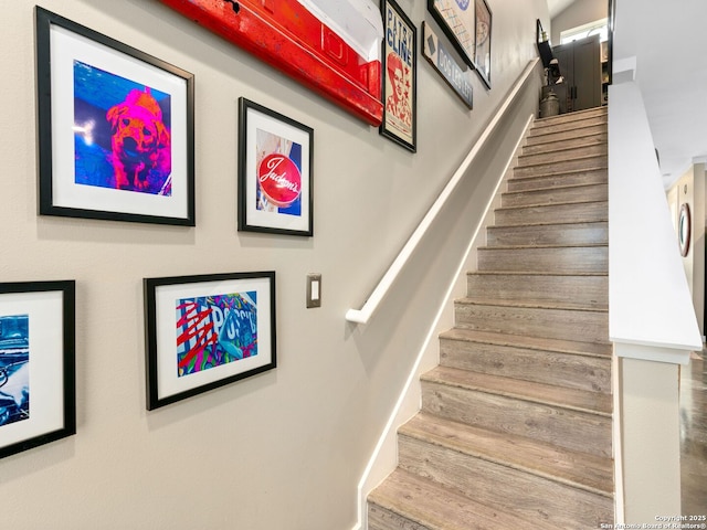 staircase with hardwood / wood-style flooring