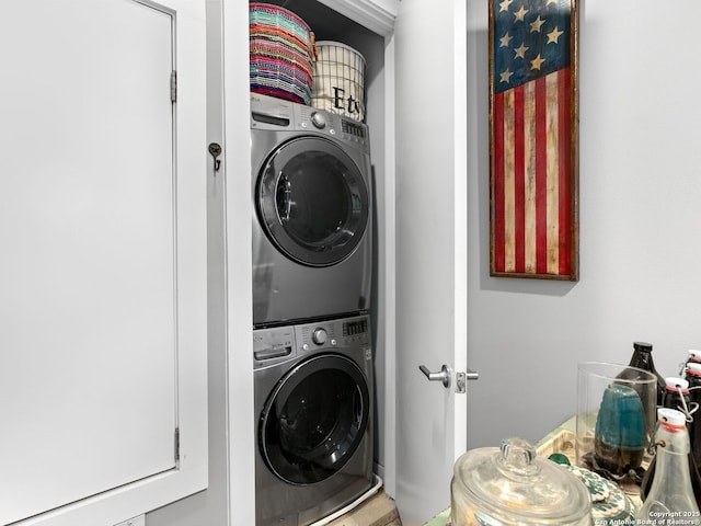 laundry area with stacked washer and dryer