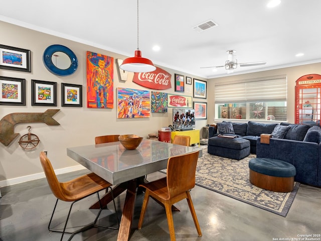 dining area with crown molding, concrete flooring, and ceiling fan