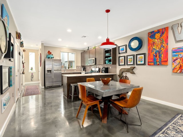 dining area with crown molding