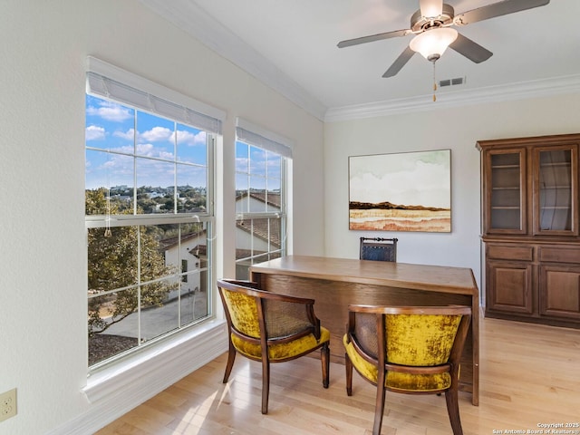 dining space featuring crown molding, ceiling fan, and light hardwood / wood-style flooring