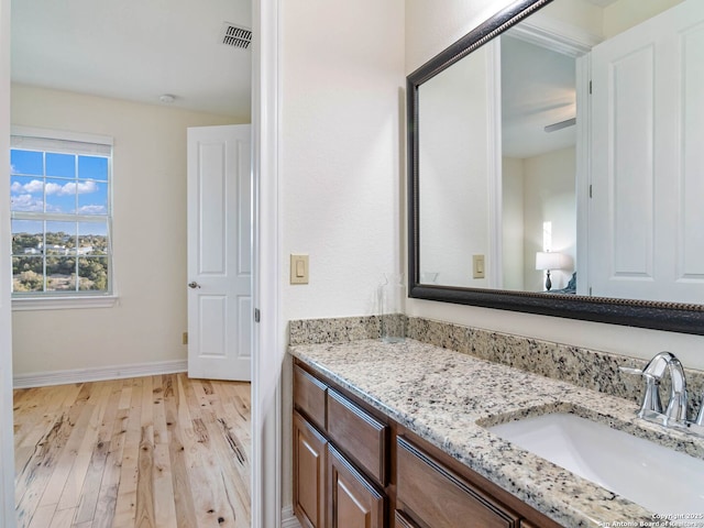 bathroom with vanity and hardwood / wood-style floors