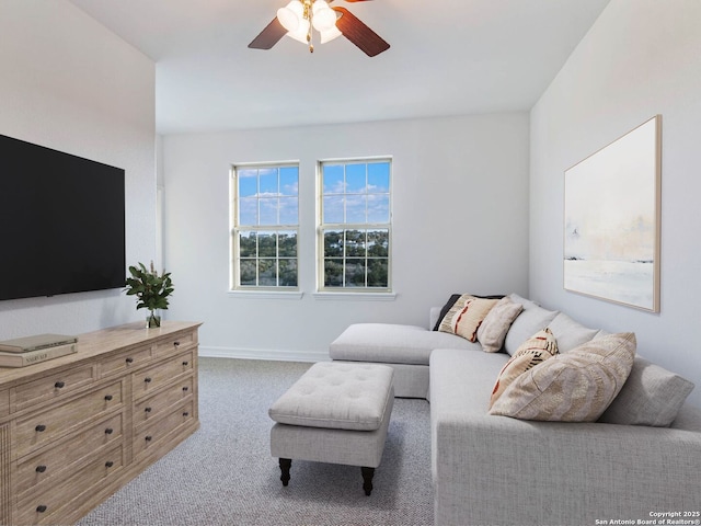 carpeted living room featuring ceiling fan