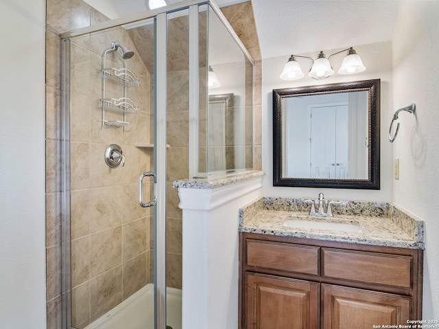 bathroom featuring vanity and an enclosed shower