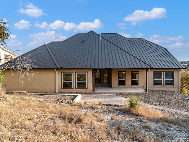 back of property featuring a patio