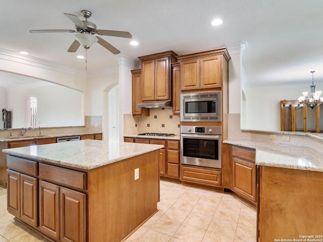 kitchen featuring stainless steel appliances, decorative light fixtures, kitchen peninsula, and light stone countertops