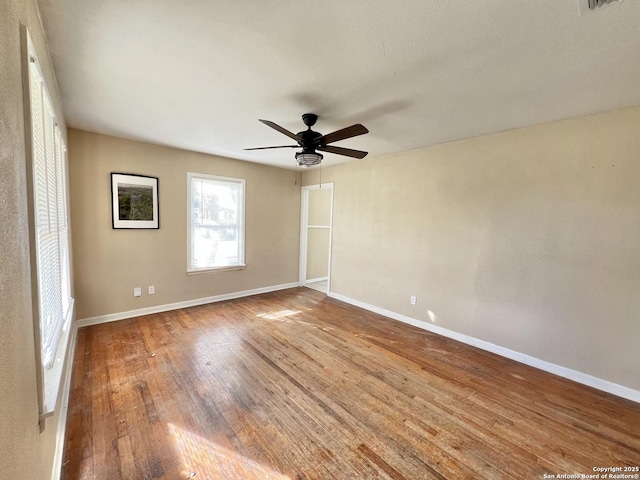 empty room with wood-type flooring and ceiling fan