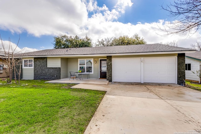 ranch-style house featuring a garage, a patio, and a front yard