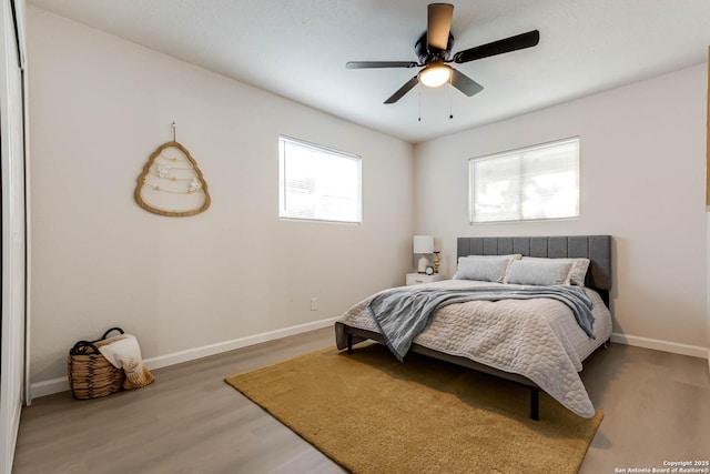 bedroom with hardwood / wood-style flooring and ceiling fan