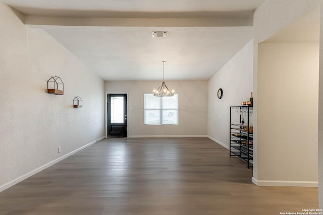 interior space featuring dark hardwood / wood-style flooring and an inviting chandelier